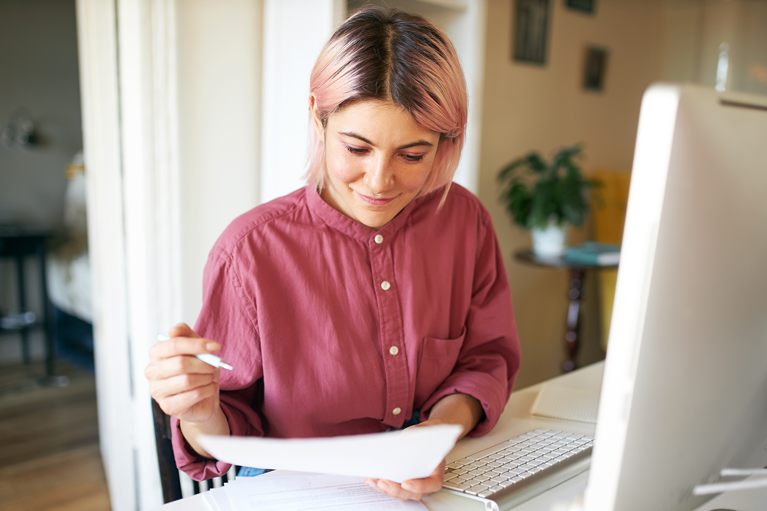 young girl learning using paper notes and computer for elearning