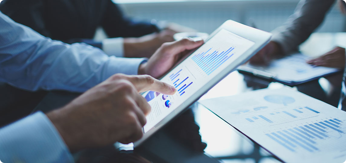 business meeting hands holding papers with data and statistics