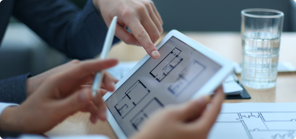 hands pointing to screen showing property floor plan